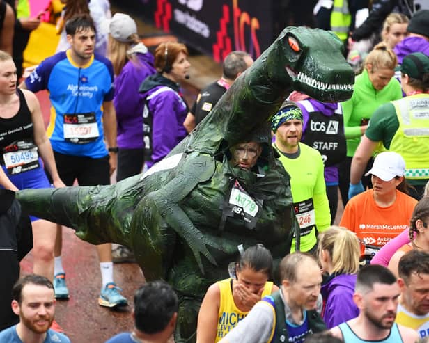 A competitor wearing a dinosaur costume during the 2023 London Marathon (Photo: Alex Davidson/Getty Images)