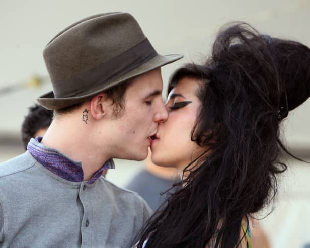 Singer Amy Winehouse kisses fiance Blake Fielder-Civil during day 1 of the Coachella Music Festival held at the Empire Polo Field on April 27, 2007 in Indio, California.  (Photo by Michael Buckner/Getty Images)