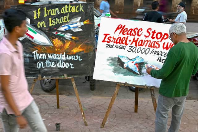 An artist paints along a street in Mumbai depicting the unrest between Palestine, Israel and Iran (Photo: INDRANIL MUKHERJEE/AFP via Getty Images)