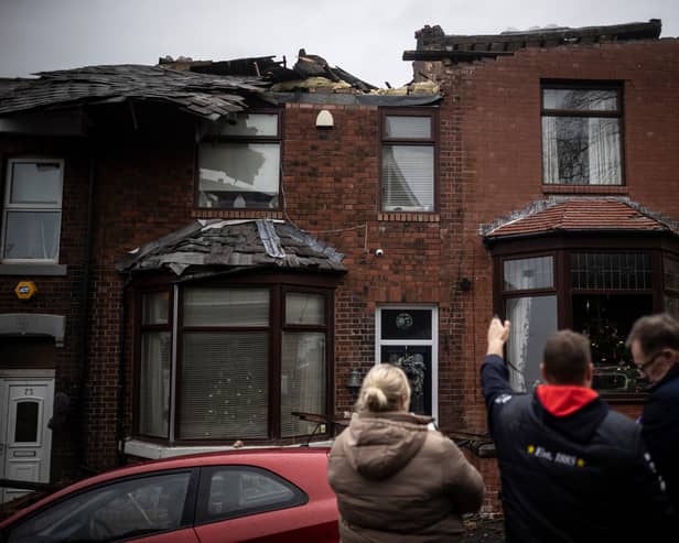 The residents of a house which had its roof ripped up assess the damage in the aftermath of a tornado in December 2023 in Stalybridge (Photo: Ryan Jenkins/Getty Images)