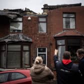 The residents of a house which had its roof ripped up assess the damage in the aftermath of a tornado in December 2023 in Stalybridge (Photo: Ryan Jenkins/Getty Images)