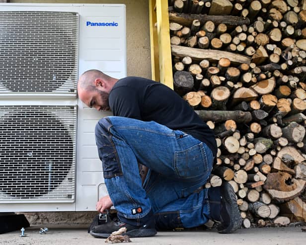 A worker installs a heat pump in a home in Saint-Didier, western France (Photo: DAMIEN MEYER/AFP via Getty Images)