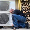 A worker installs a heat pump in a home in Saint-Didier, western France (Photo: DAMIEN MEYER/AFP via Getty Images)