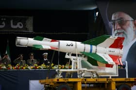 An Iranian surface to surface Ghasedak missile is driven past portraits of Iran's late founder of the Islamic Republic, Ayatollah Ali khamenei, during the annual army day military parade in 2008 (Photo: Majid/Getty Images)