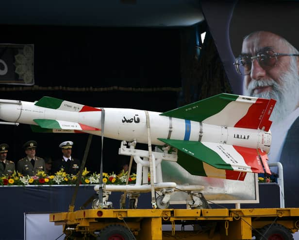 An Iranian surface to surface Ghasedak missile is driven past portraits of Iran's late founder of the Islamic Republic, Ayatollah Ali khamenei, during the annual army day military parade in 2008 (Photo: Majid/Getty Images)