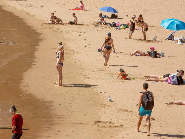 People sunbathe at Las Teresitas beach, in Santa Cruz de Tenerife (Photo: DESIREE MARTIN/AFP via Getty Images)