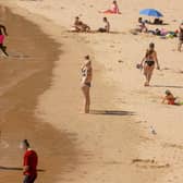 People sunbathe at Las Teresitas beach, in Santa Cruz de Tenerife (Photo: DESIREE MARTIN/AFP via Getty Images)