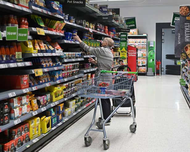 A customer looks at goods at the Asda supermarket in Aylesbury, England (Photo: JUSTIN TALLIS/AFP via Getty Images)