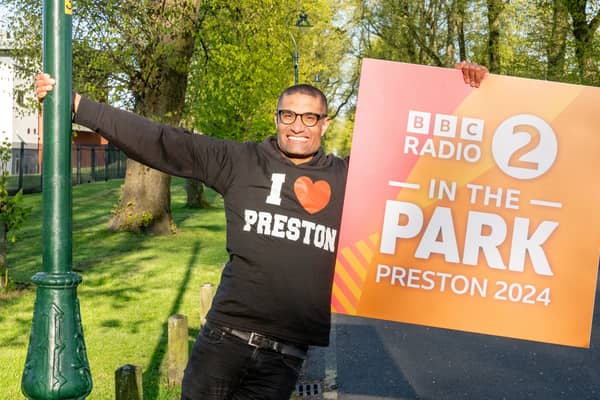 Richie Anderson holds a sign which announces BBC Radio 2's flagship live music festival In The Park will take place in Moor Park, Preston on September 7 and 8. Picture: BBC/PA Wire 
