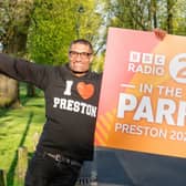 Richie Anderson holds a sign which announces BBC Radio 2's flagship live music festival In The Park will take place in Moor Park, Preston on September 7 and 8. Picture: BBC/PA Wire 