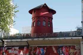 The iconic red windmill that featured on the outside of the famous Paris cabaret club Moulin Rogue has collapsed. (Credit: Getty Images)