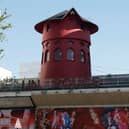The iconic red windmill that featured on the outside of the famous Paris cabaret club Moulin Rogue has collapsed. (Credit: Getty Images)
