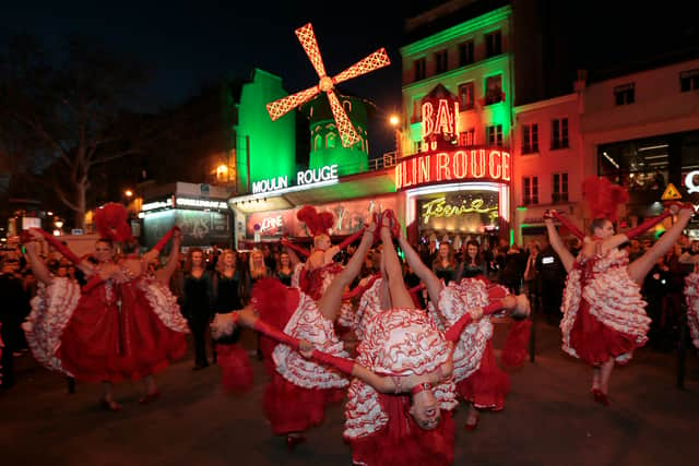 The famous red windmill outside the Moulin Rouge is usually illuminated. (Credit: Getty Images)