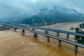 A highway in China has collapsed, killing 19 people, after its most populous province experienced its heaviest rainfall since records began. (Credit: AFP via Getty Images)