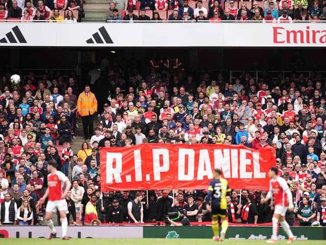 Fans hold up a banner in memory of 14-year-old Arsenal fan Daniel Anjorin, who died following the sword attack in east London this week (Photo: Adam Davy/PA Wire)