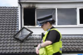 A police officer at the scene of a fatal house fire in Bradford. Credit: Danny Lawson/PA Wire