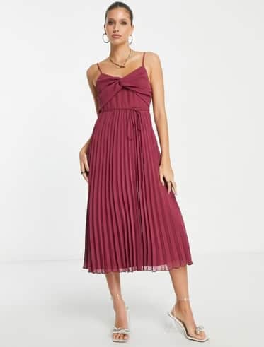 ASOS DESIGN twist front pleated cami midi dress with belt in oxblood red. Photo by Secret Sales.