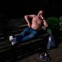 A person rests on a bench along the Regent's Canal in London. Picture: BENJAMIN CREMEL/AFP via Getty Images