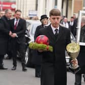 A football being carried carried into St Mary And St Eanswythe Church, Folkestone ahead of the funeral of William Brown. Picture: Gareth Fuller/PA Wire