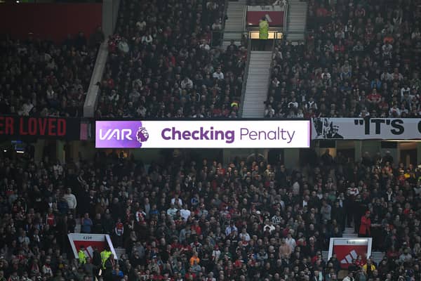 The LED board shows VAR checking for a penalty during the Premier League match between Manchester United and Manchester City at Old Trafford