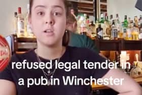 The assistant manager behind the bar is told she 'must' accept cash as it is 'legal tender' - this is not true (Photo: TikTok)