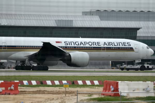 One person has died and more than 30 other people have been injured after a Singapore Airlines flight flying from London to Singapore was hit by severe turbulence. (Credit: ROSLAN RAHMAN/AFP via Getty Images)