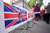A banner and protestors outside Downing Street this afternoon