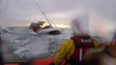 Dramatic footage shows the terrifying moment huge waves crashed into a yacht- seconds before rescue. 