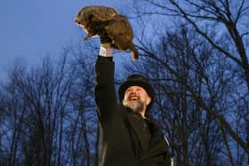 Groundhog handler AJ Dereume holds Punxsutawney Phil after he did not see his shadow predicting an early Spring in 2024