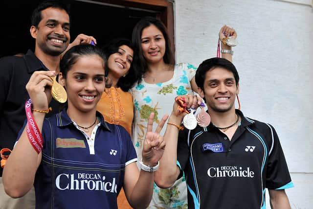 Badminton stars Saina Nehwal and husband  Parupalli Kashyap split after nearly seven years of marriage. Indian badminton medalists Saina Nehwal (L) with gold, Parapulli Kashyap with bronze (R) and the women's doubles gold medalists Ashwini Ponnappa and Jwala Gutta (C) pose with coach P.Gopichand (top-L) prior to a press conference in Hyderabad on October 16, 2010. Photo: Getty Images