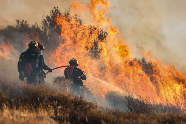 Multiple wildfires have erupted in holiday hotspots in Greece prompting evacuations, power outages, and large-scale firefighting efforts. (Photo: AFP via Getty Images)