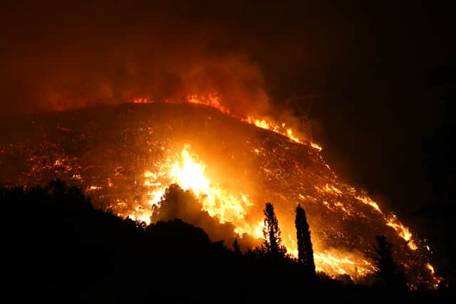 Firefighters are battling wildfires in Greece as tourists and locals have been evacuated from blazes that are raging. (Photo: SOOC/AFP via Getty Images)