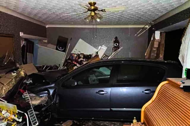 A vehicle ploughed into the front of the house at about 1am on Sunday. A man has been arrested on suspicion of dangerous driving, drink-driving, criminal damage, and aggravated vehicle taking. He was additionally arrested on suspicion of driving without a valid licence and driving without the correct insurance.