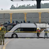 Military personnel stand guard after a fatal collision between a freight train and a passenger bus in Toluca, Mexico