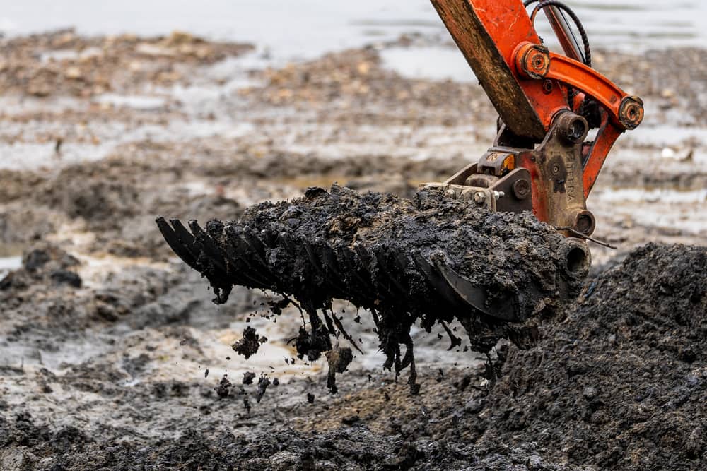 A digger scooping up wet wipes from the river foreshore in west London. Congealed rubbish equivalent to around five million wet wipes has been cleared from the banks of the River Thames as a major project to remove the so-called "wet wipe island" reaches completion