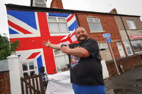 Simon Brocklehurst of Sutton in Ashfield, Notts, with his freshly painted Union Jack house.  September 18, 2025.  //  Residents say they fear for property price values along their street - after their neighbour painted a giant Union Jack on the front of his entire house.  Simon Brocklehurst spent 12 hours plastering the 6m (19ft) x 7m (22ft) flag on his four bed end-terraced home in in Sutton-in-Ashfield, Notts.  The 41-year-old welder's patriotic gesture came after neighbours tore down a St George's flag which he had been flying in his front garden.  Simon admits his response has seen him become "public enemy number one" but insists he's mainly received praise for his display.  However, some locals have said they now worry the red, white and blue paint-job would now devalue their homes if they wanted to sell up. 