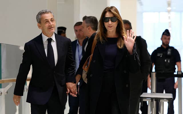 Former French president Nicolas Sarkozy with his wife Carla Bruni arrives for the verdict in his trial for illegal campaign financing from Libya for his successful 2007 presidential bid, at the Tribunal de Paris courthouse in Paris, on September 25, 2025. Photo: Getty Images