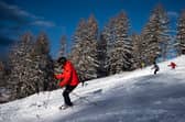 Skiers ski down a slope of the Italian ski resort of Sestriere, Piedmont