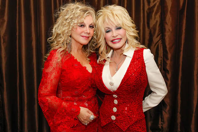 What is wrong with Dolly Parton healthwise, how old is she, who are her siblings? Stella Parton and Dolly Parton attend Stella Parton's Red Tent Women's Conference 2014 at the Doubletree Hotel Downtown on April 18, 2014 in Nashville, Tennessee. (Photo by Terry Wyatt/Getty Images)