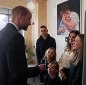 The Prince of Wales speaks with Lindsey Burrow, wife of the late rugby league player Rob Burrow, and their children Macy, Maya and Jackson, as rugby union coach Kevin Sinfield, who has raised more than 10 million pounds for motor neurone disease charities since 2019 stands nearby