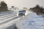 Vehicles drive on the A9 in Inverness, as snow, rain and wind warnings are in force and are expected to cause travel issues on New Year's Eve