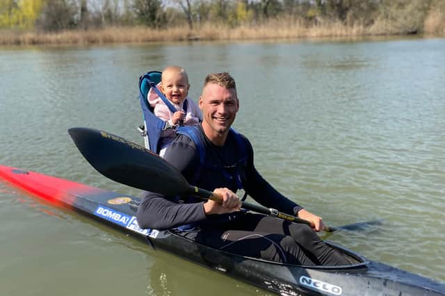 Miklos Dudas poses with his child in undated photo. The world champion kayaker was found dead in Budapest, Hungary. (Newsflash)