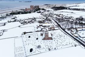 Bamburgh Castle surrounded by snow in Northumberland