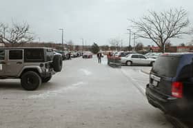 Cars fill the parking lot of a  grocery store in Lenexa, Kansas as a massive winter storm is bringing frigid temperatures, ice, and snow to millions of Americans