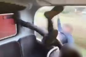 Horrifying footage shows the moment two schoolboys plunged out of a window from the top deck of a moving bus