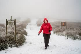 A person walks through snow and foggy conditions near the Tan Hill Inn, which claims to be "Britain´s highest public house at 1,732 feet (528m) above sea level", in Richmond, North Yorkshire