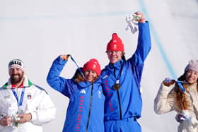 Team GB's Charlotte Bankes and Huw Nightingale won gold in the Mixed Team Snowboard Cross Big Final.