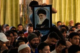Shiite Muslims mourn the killing of Iranian Supreme Leader Ayatollah Ali Khamenei during a special prayer in Jammu, India