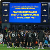 Players stand during a pause as observing Muslim players break the Ramadan fast during the Premier League soccer match between Leeds United and Manchester City