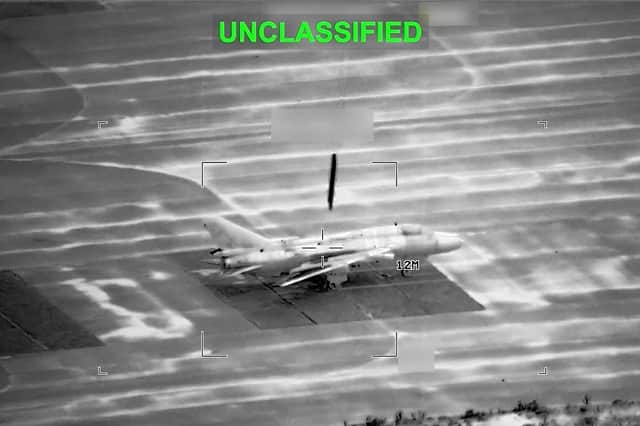 This partially redacted image from video provided by U.S. Central Command shows a military aircraft in Iran shortly before it was struck by a missile fired by U.S. forces